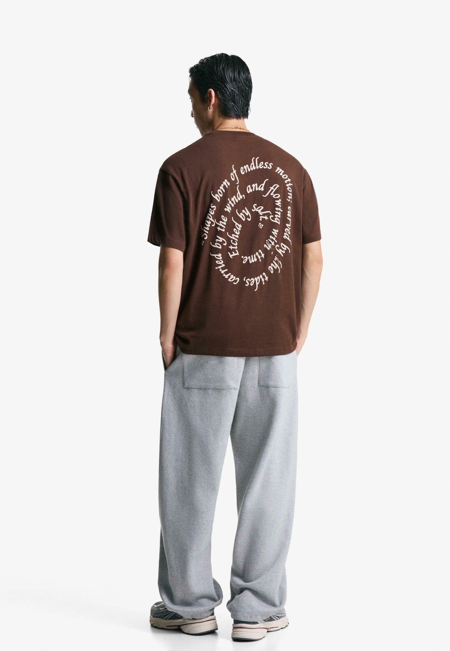 Bershka dark brown short-sleeve t-shirt with a small circular graphic on the tront chest.