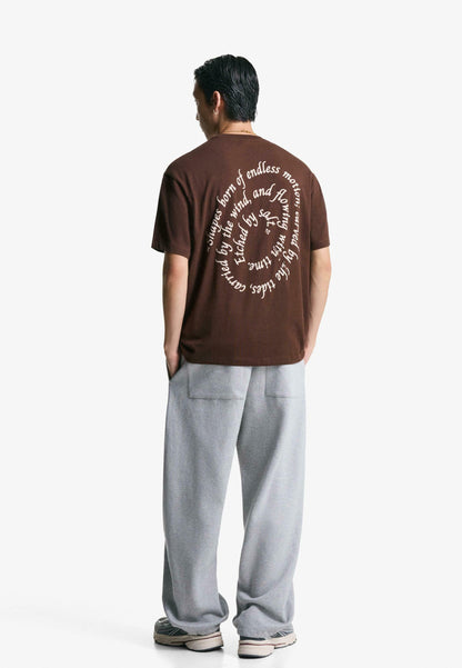 Bershka dark brown short-sleeve t-shirt with a small circular graphic on the tront chest.